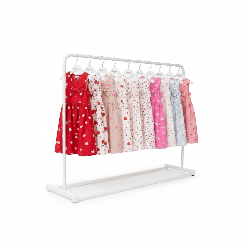 The Nile Luxuries sleeveless A-line dresses for girls in various vibrant prints and colors on a white clothing rack.