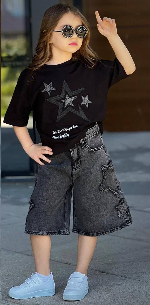 The Nile Luxuries girls' black t-shirt with star print and distressed denim shorts with star cutouts.