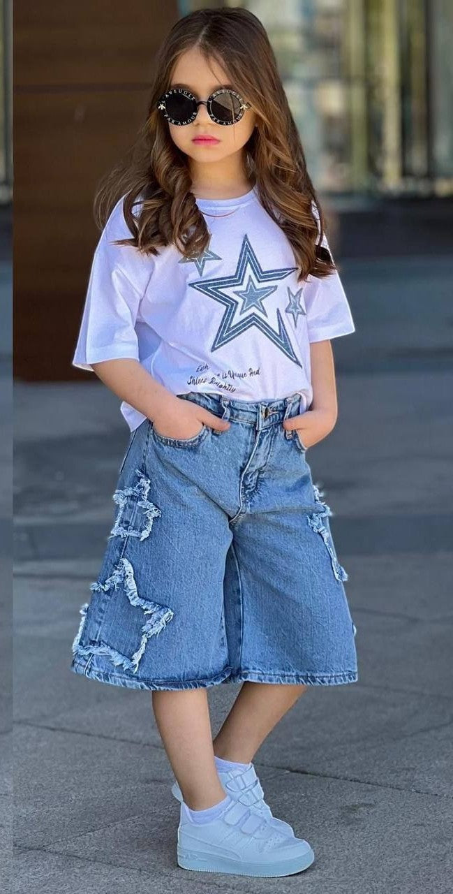 The Nile Luxuries girls white t-shirt with star print and distressed denim shorts with star cutouts.