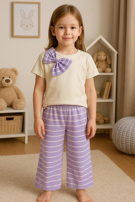The Nile Luxuries girls pajama set with a cream crew-neck top, purple striped bow, and matching wide-leg striped pants.