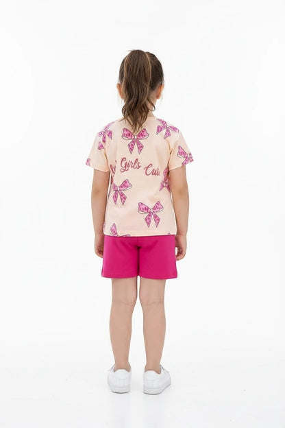 The Nile Luxuries girls' summer set with a peach bow-print t-shirt and vibrant pink shorts for casual play.