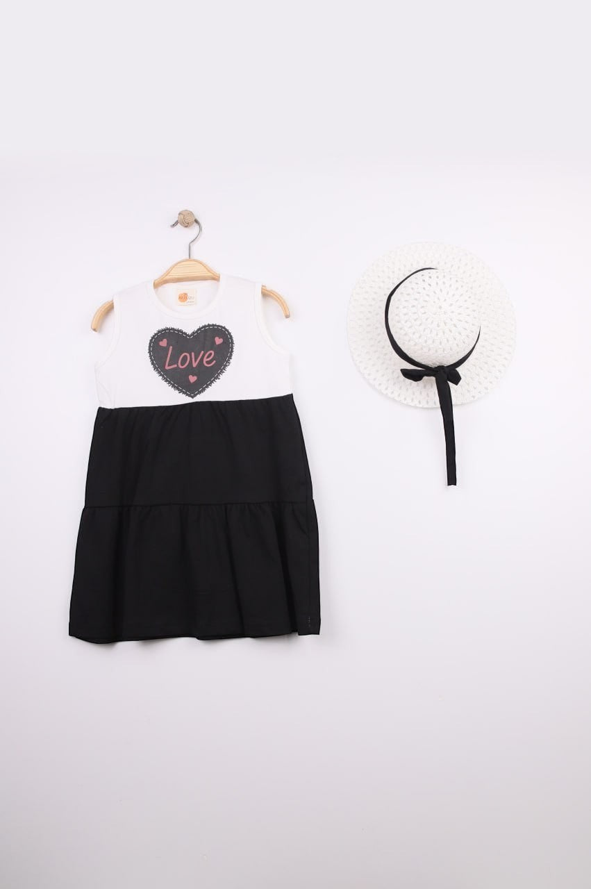 The Nile Luxuries Girls white tiered dress with black skirt, featuring a heart graphic with 'Love' and pink stitching. Includes matching hat.