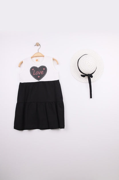 The Nile Luxuries Girls white tiered dress with black skirt, featuring a heart graphic with 'Love' and pink stitching. Includes matching hat.