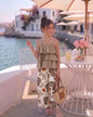 The Nile Luxuries girls' tiered ruffle camisole top in tan paired with wide-leg palazzo pants featuring a tropical leaf and floral print.