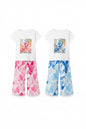 The Nile Luxuries girls' two-piece outfit with white graphic t-shirt and pink or blue tropical leaf print trousers.