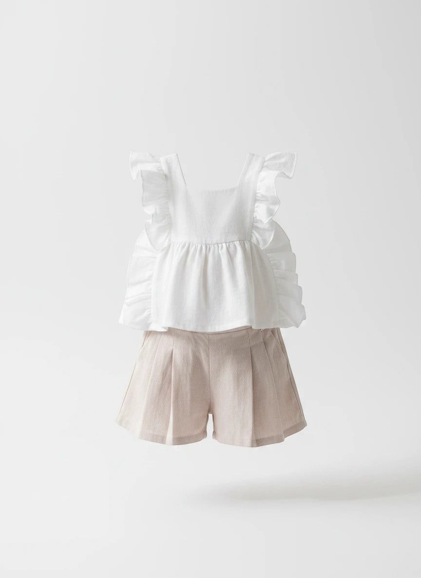 The Nile Luxuries girls' white ruffled sleeve top with floral embroidery and beige pleated shorts.