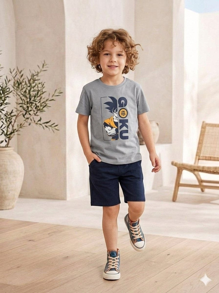 The Nile Luxuries grey Dragon Ball Z Goku graphic t-shirt worn by a young boy with navy shorts and sneakers.