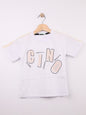 The Nile Luxuries white cotton t-shirt for kids with abstract graphic print and stylized lettering.