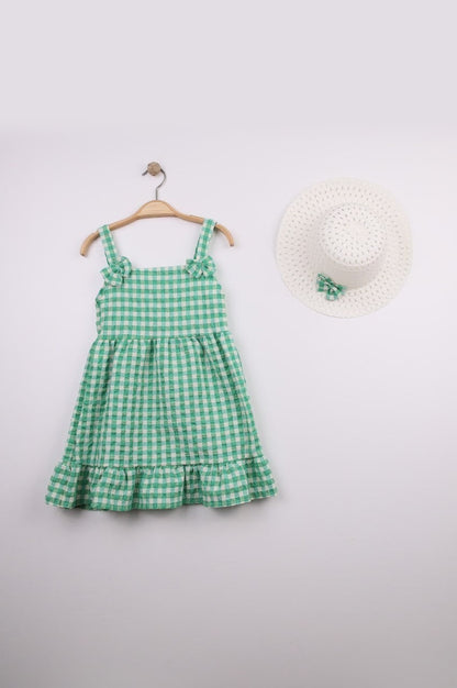 The Nile Luxuries green and white gingham ruffle dress with bow straps and matching hat. Lightweight fabric, perfect for summer.