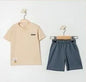 The Nile Luxuries children's beige t-shirt with chest pocket and grey shorts set. Soft, breathable fabric for casual wear.