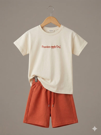 The Nile Luxuries children's cream cotton t-shirt with Freedom made On! graphic and rust-colored drawstring shorts set.