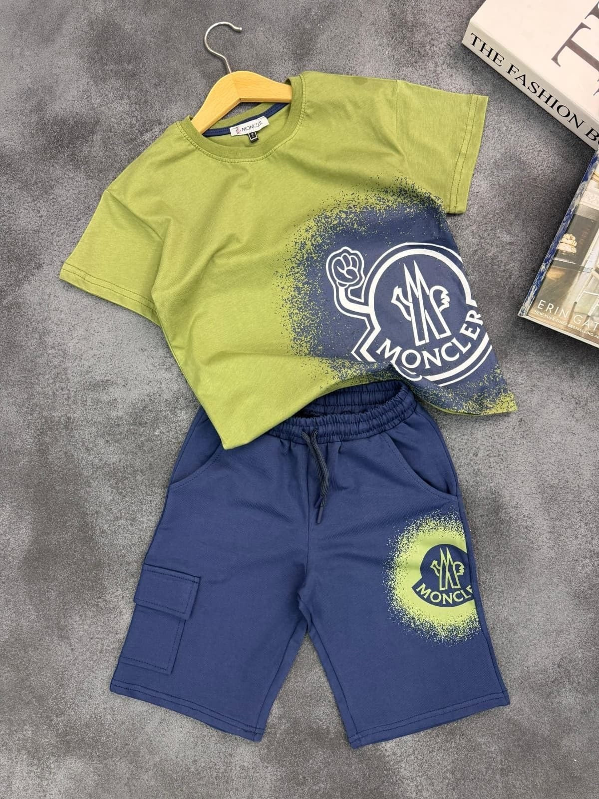 The Nile Luxuries kids graphic t-shirt and cargo shorts set in olive green and navy blue with spray-paint logo print.
