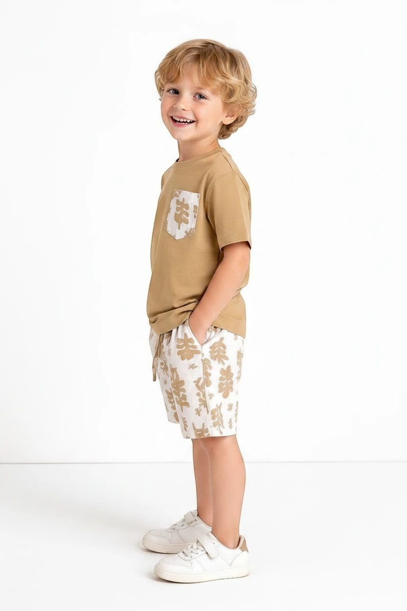 The Nile Luxuries boys' tan t-shirt with leaf print pocket and matching leaf print shorts. Comfortable summer set.