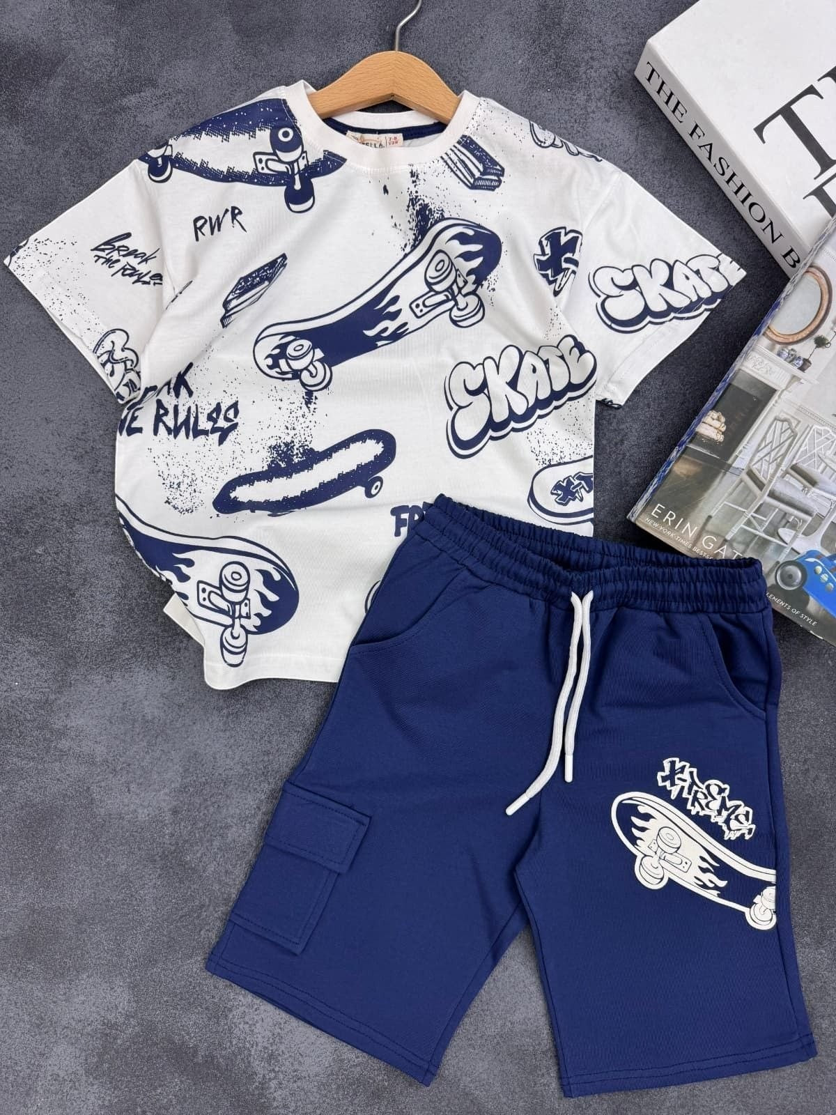 The Nile Luxuries kids set with white skateboard graphic t-shirt and navy blue cargo shorts with drawstring waist.