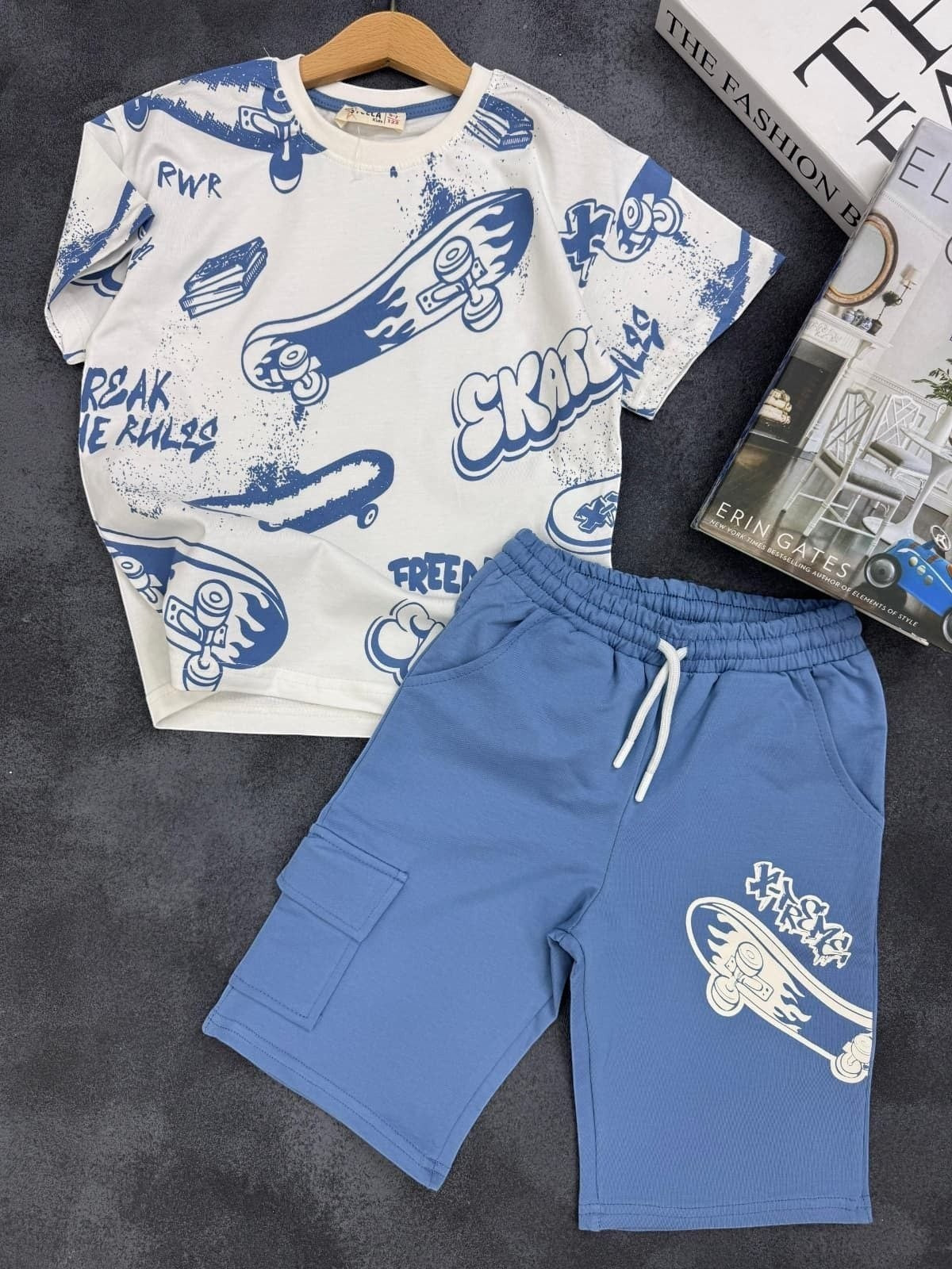 The Nile Luxuries kids set with white graphic t-shirt and blue cargo shorts featuring skateboard print and drawstring.
