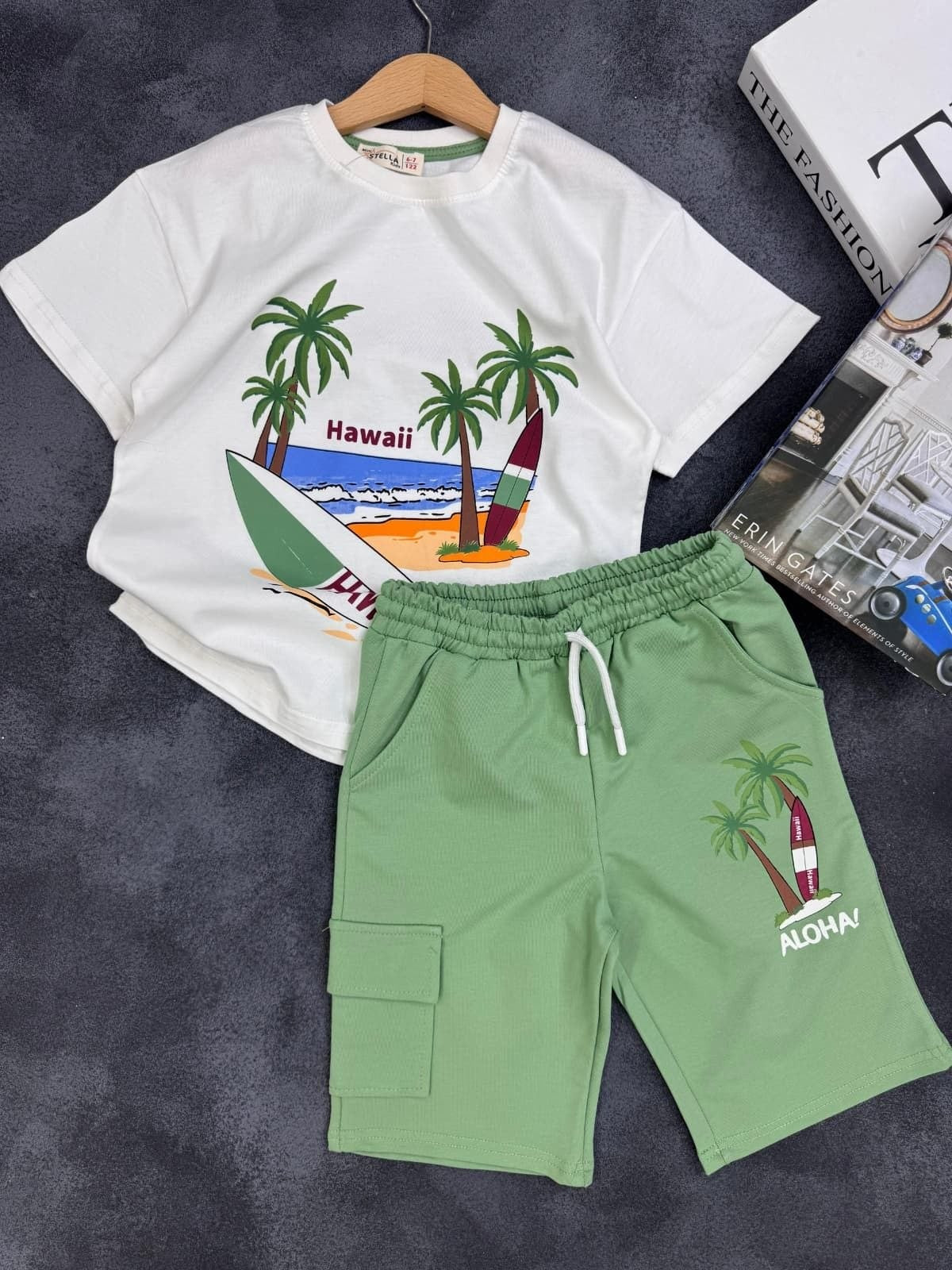 The Nile Luxuries kids summer set with white Hawaii graphic t-shirt and sage green cargo shorts with drawstring.