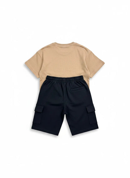 The Nile Luxuries kids two-piece set with a tan t-shirt and black cargo shorts featuring side pockets.