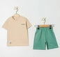 The Nile Luxuries children's beige t-shirt with chest pocket and green shorts set. Soft, breathable fabric, elastic waistband.