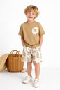 The Nile Luxuries boys' tan t-shirt with leaf print pocket and matching leaf print shorts.