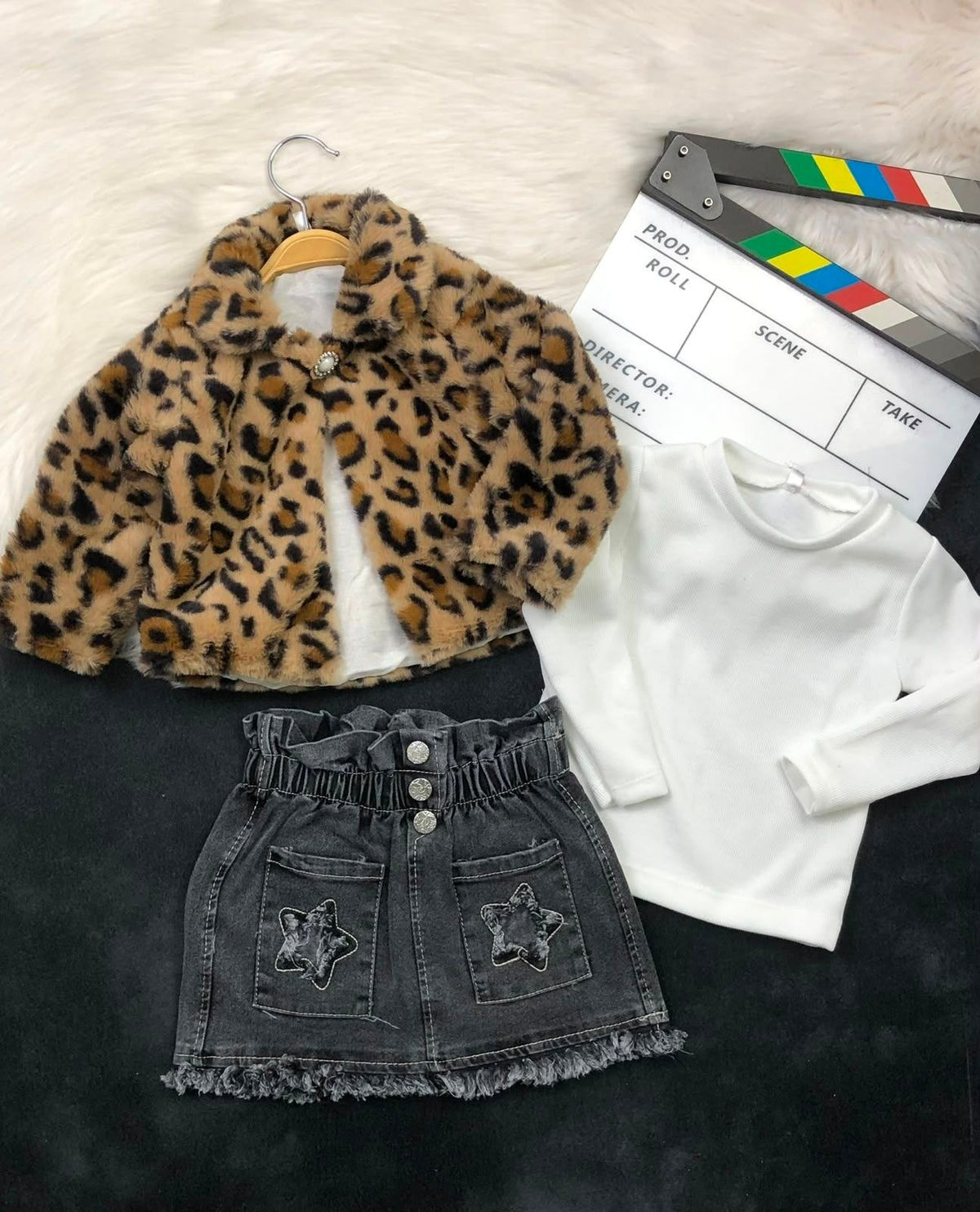 The Nile Luxuries three-piece children's outfit with a leopard faux-fur jacket, white ribbed top, and denim skirt.
