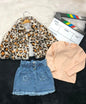 The Nile Luxuries three-piece set with a leopard faux-fur jacket, peach ribbed top, and denim star-pocket skirt.