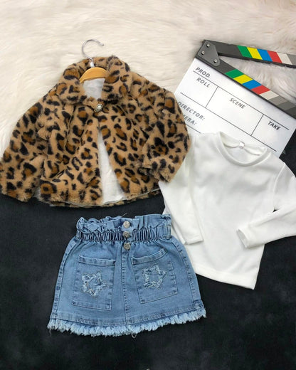 The Nile Luxuries three-piece outfit with leopard faux-fur jacket, white ribbed top, and denim skirt with star pockets.