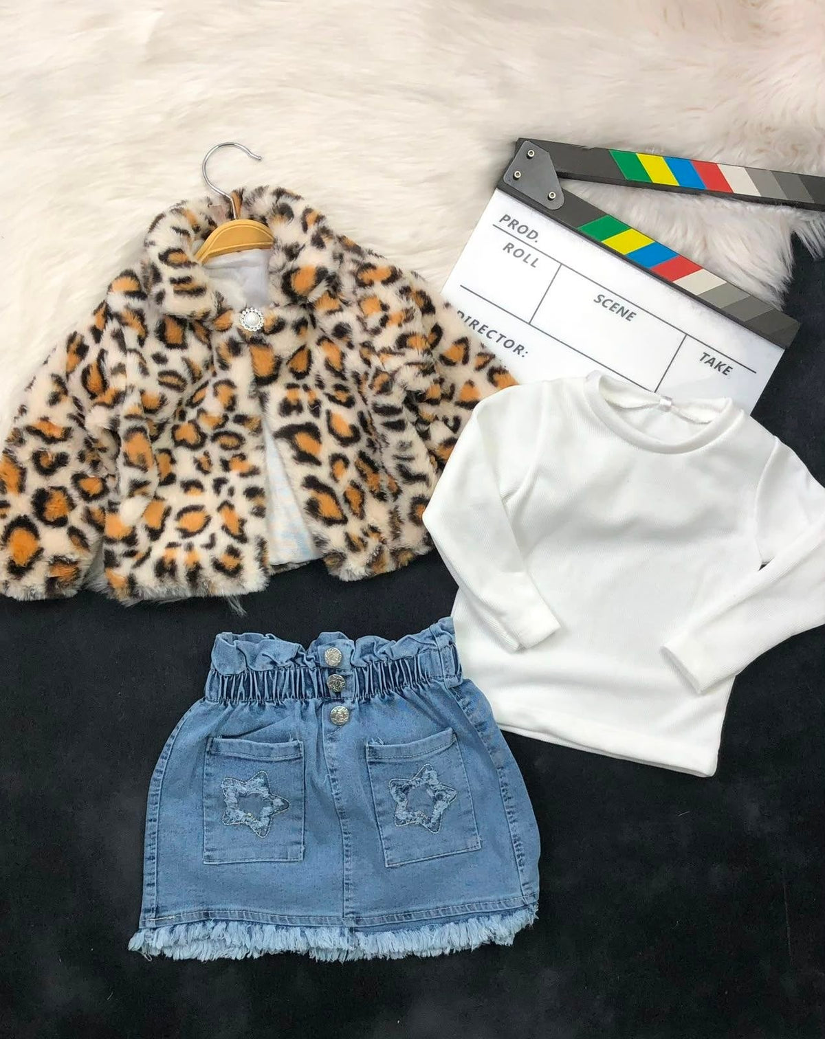 The Nile Luxuries three-piece outfit with a leopard faux-fur jacket, white ribbed top, and denim star-pocket skirt.