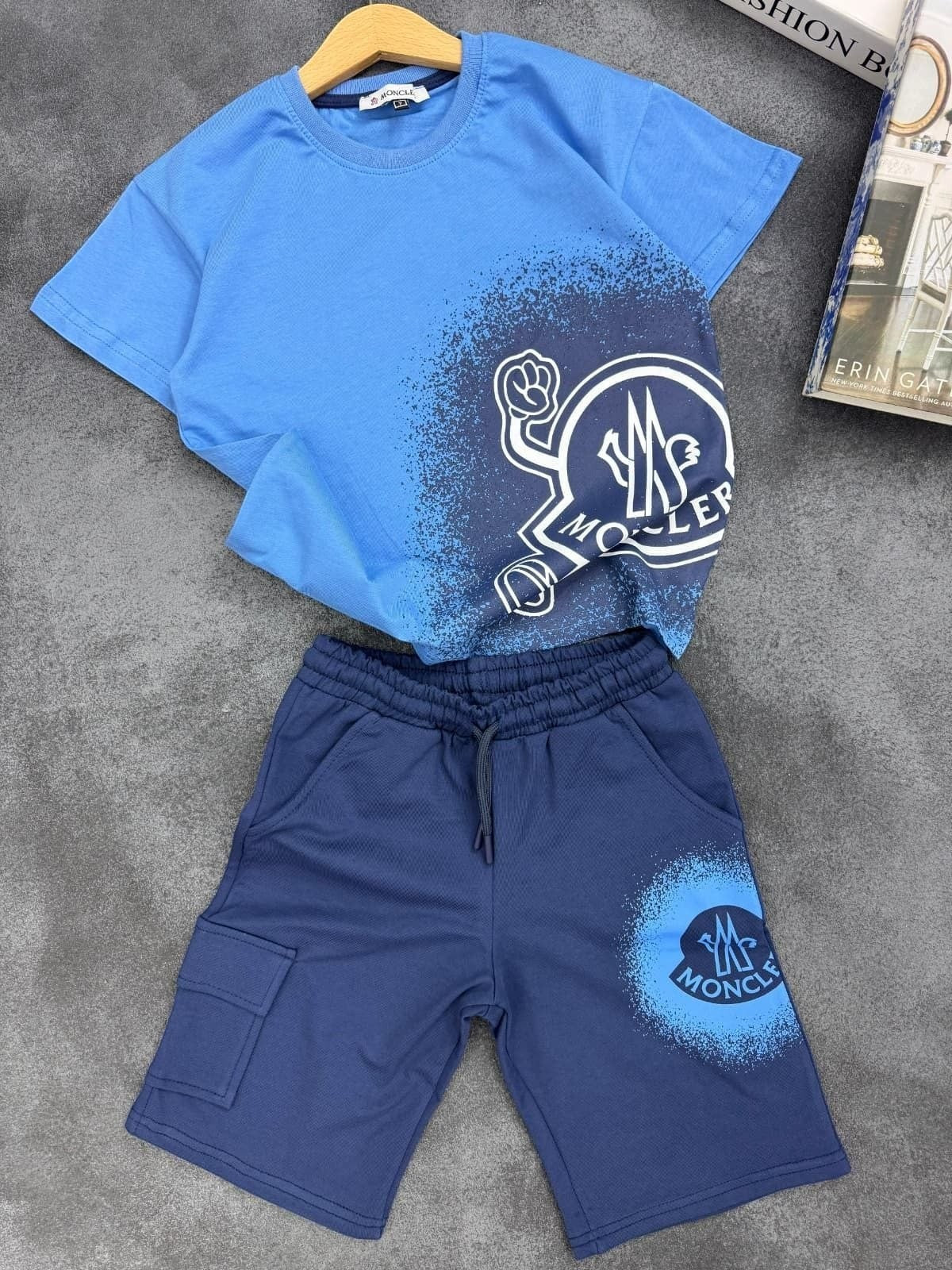 The Nile Luxuries blue Moncler graphic t-shirt and cargo shorts set with spray-paint logo print and drawstring waist.