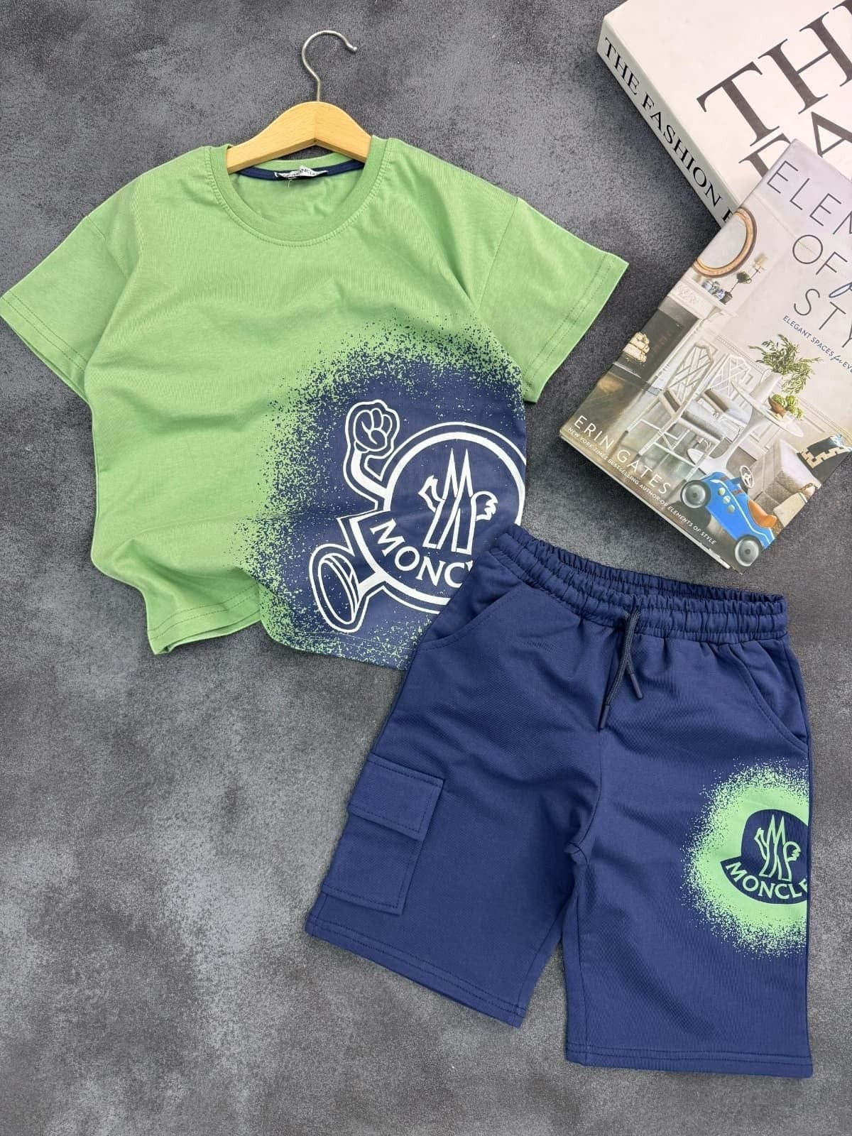 The Nile Luxuries kids Moncler green t-shirt and navy blue cargo shorts set with spray-paint graphic logo print.
