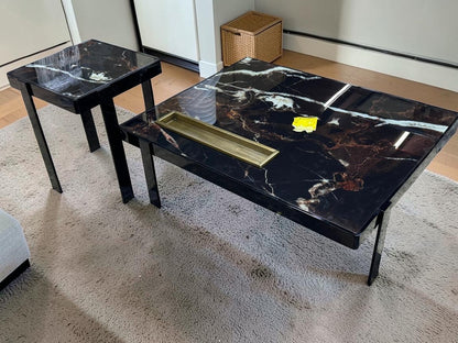 The Nile Luxuries nesting accent tables with black marble-effect tops and black metal legs. Features white and copper veining.