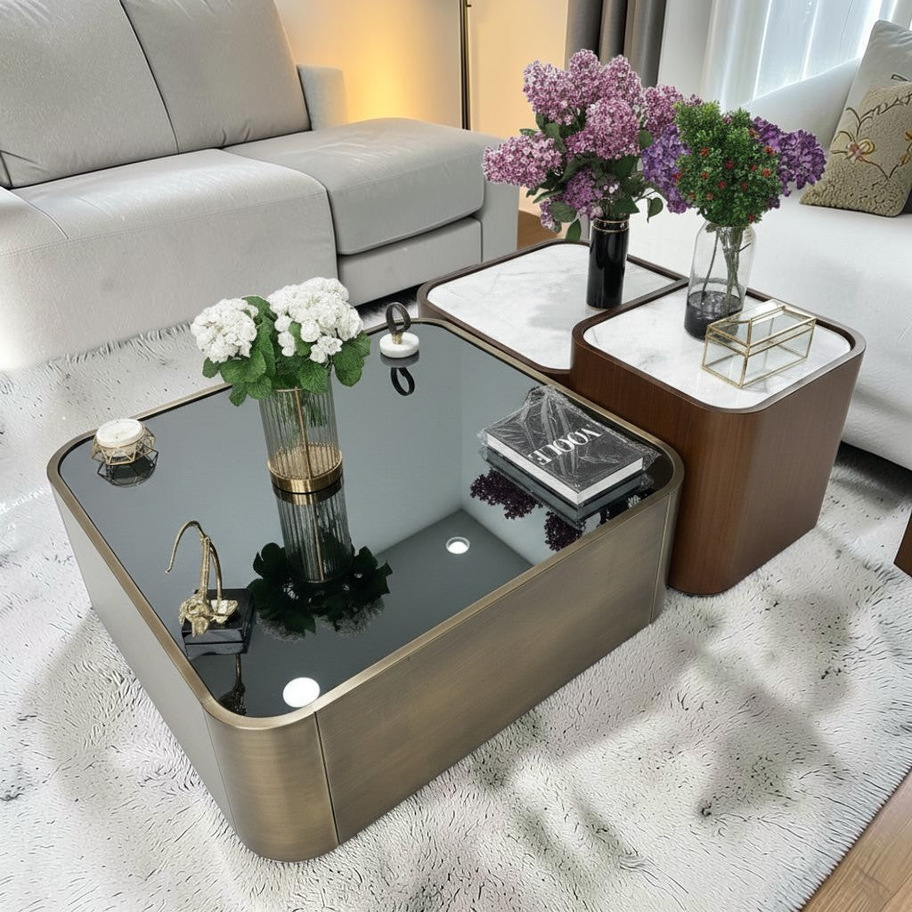 The Nile Luxuries nesting coffee table set with black glass top and brass base, and white marble top with wood veneer sides.