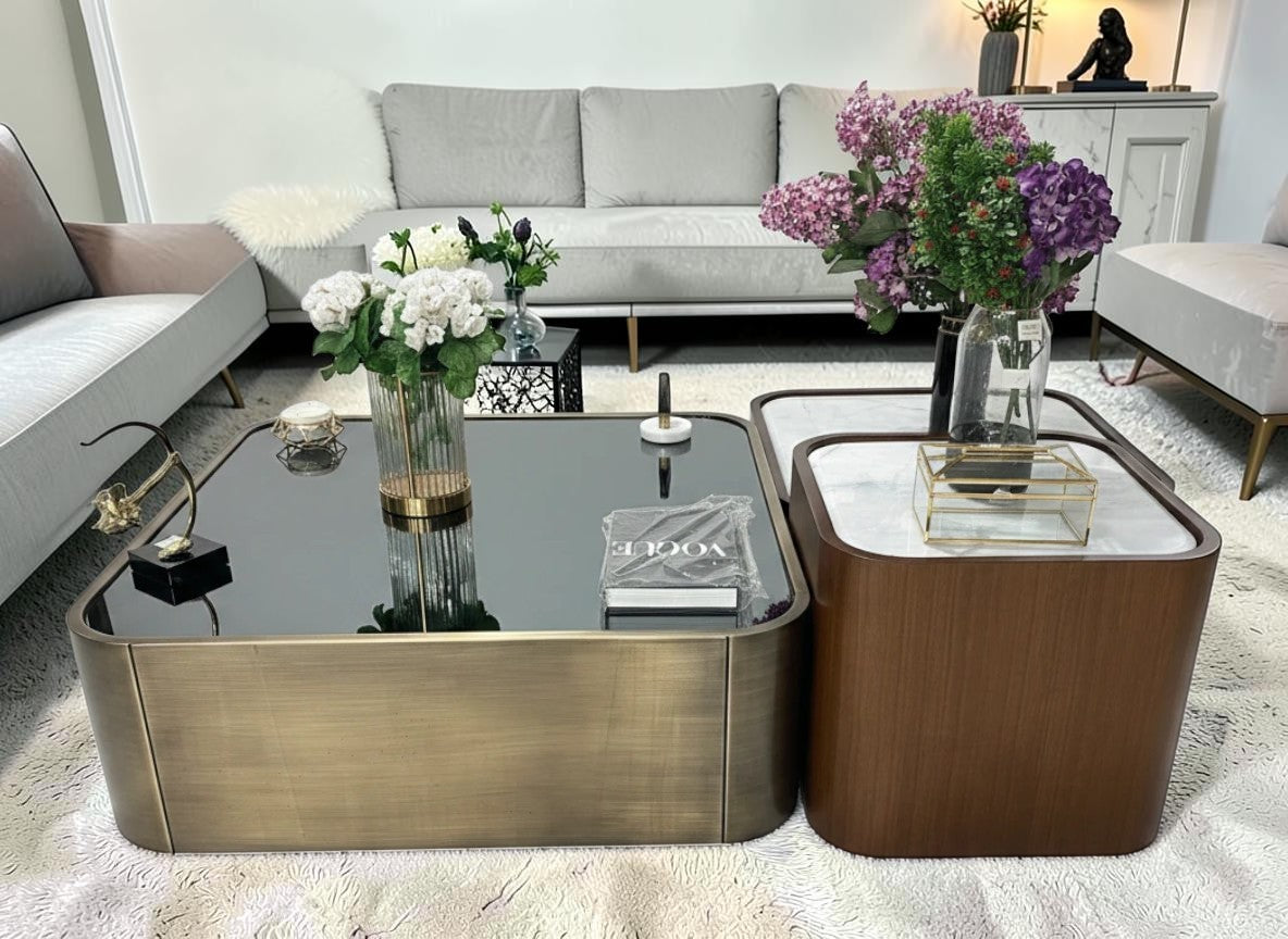 The Nile Luxuries nesting coffee table set with black glass top and brass base, and white marble top with wood veneer sides.