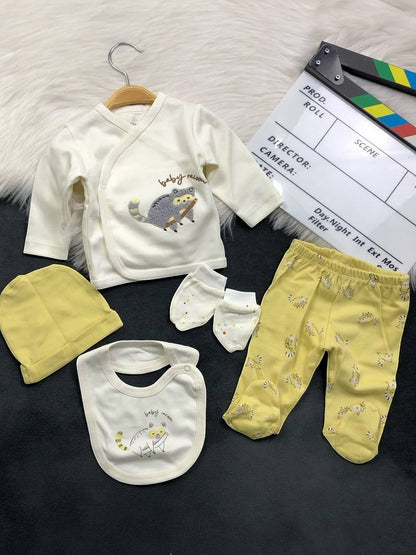 The Nile Luxuries 5-piece newborn cotton layette set featuring a raccoon print, yellow footed leggings, and beanie.