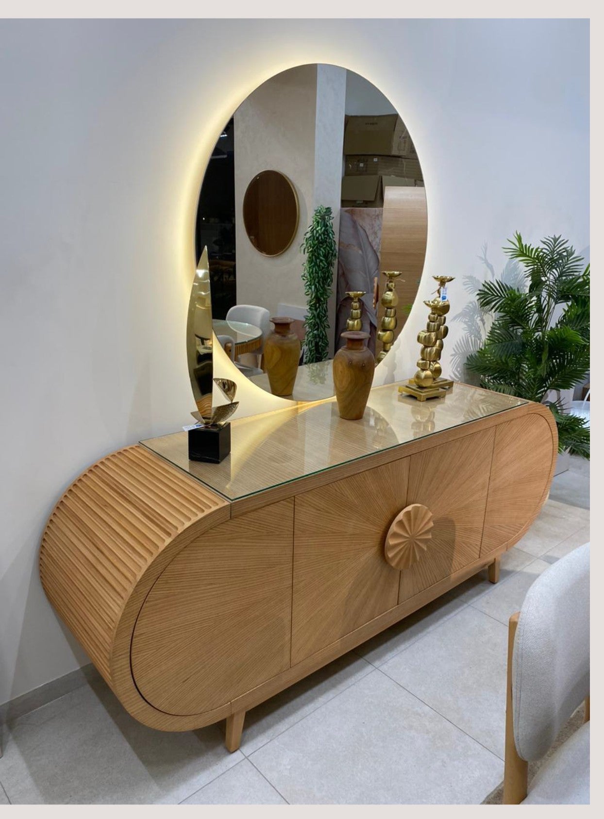 The Nile Luxuries modern oval dining set with mirrored buffet, featuring natural wood and glass.