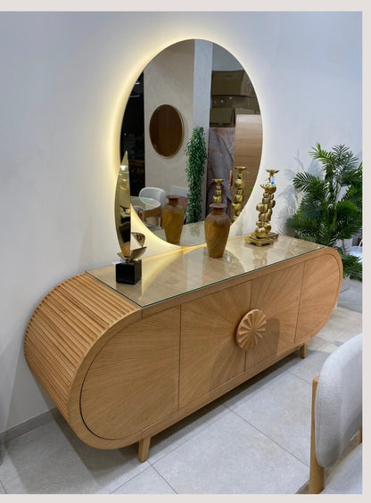 The Nile Luxuries modern oval dining set with mirrored buffet, featuring natural wood and glass.