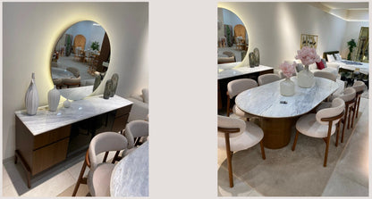 The Nile Luxuries oval marble dining table with dark wood base and upholstered chairs, seats 8. Buffet with marble top and dark wood drawers.