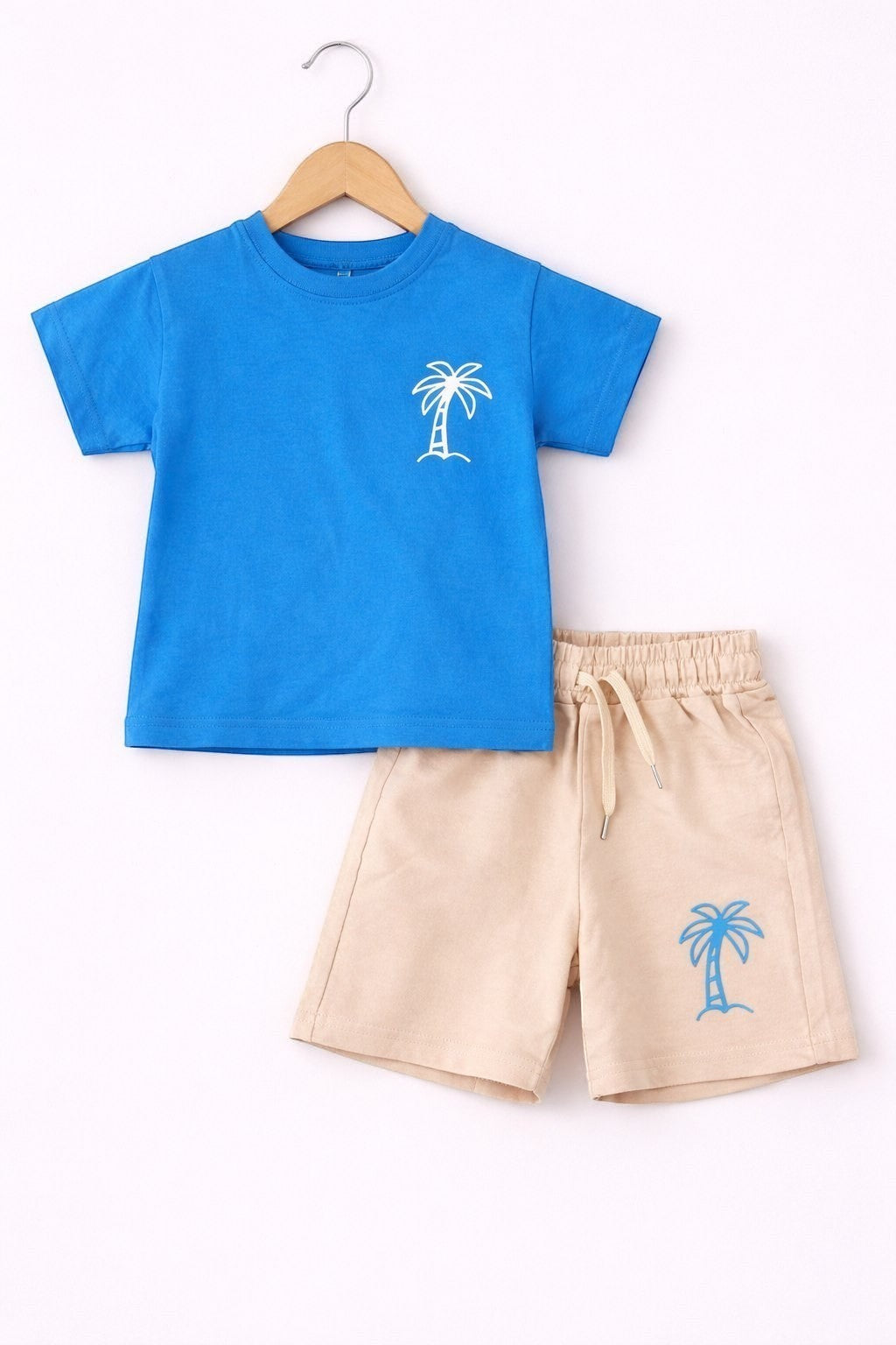 The Nile Luxuries children's blue short-sleeve t-shirt and beige shorts set with palm tree graphics.
