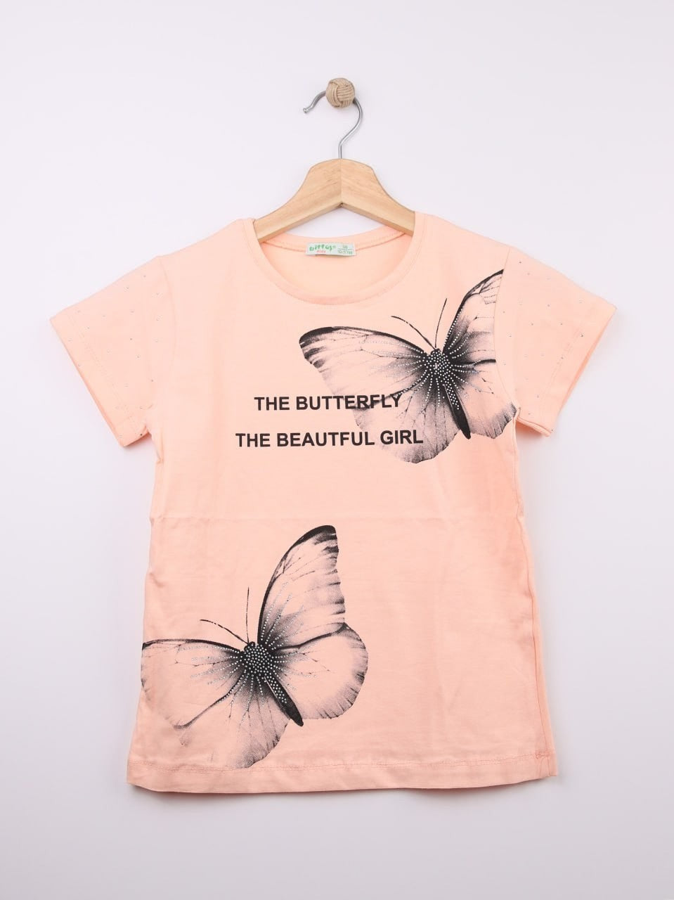 The Nile Luxuries peach cotton blend t-shirt with rhinestone butterfly graphic and text.