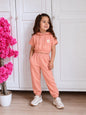 The Nile Luxuries girls peach short-sleeve cropped hoodie and jogger set with a daisy graphic and side pockets.
