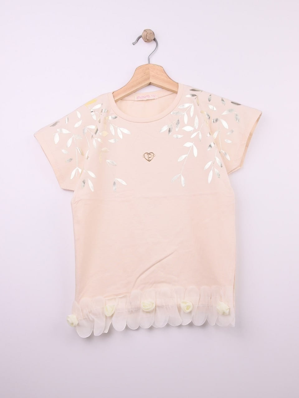 The Nile Luxuries peach cotton t-shirt with metallic leaf print, gold heart emblem, and ruffled hem with fabric roses.