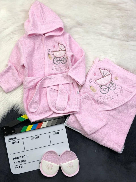 The Nile Luxuries pink hooded baby bathrobe, towel, and slippers set with embroidered baby carriage design.