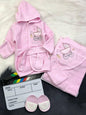 The Nile Luxuries pink hooded baby bathrobe, towel, and slippers set with embroidered baby carriage design.