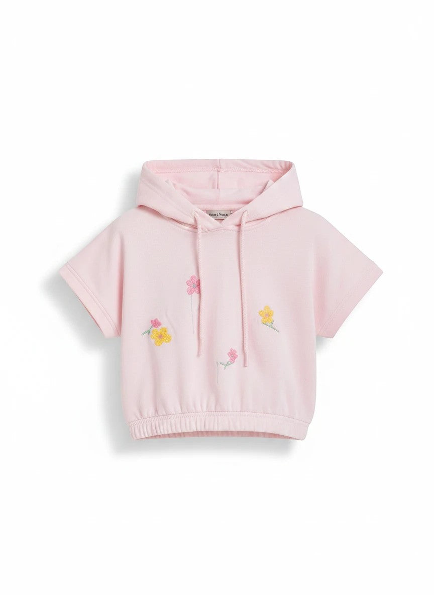 The Nile Luxuries light pink short-sleeve hoodie for girls featuring delicate embroidered floral details and a hood.