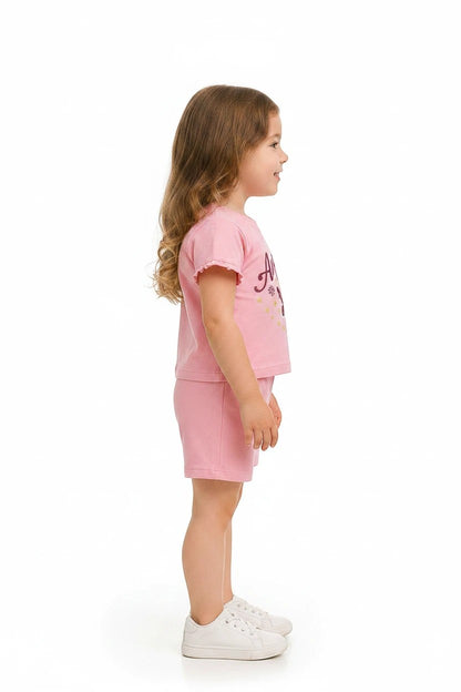 The Nile Luxuries pink short sleeve t-shirt and shorts set with ruffled sleeves and Angel graphic on a young girl.