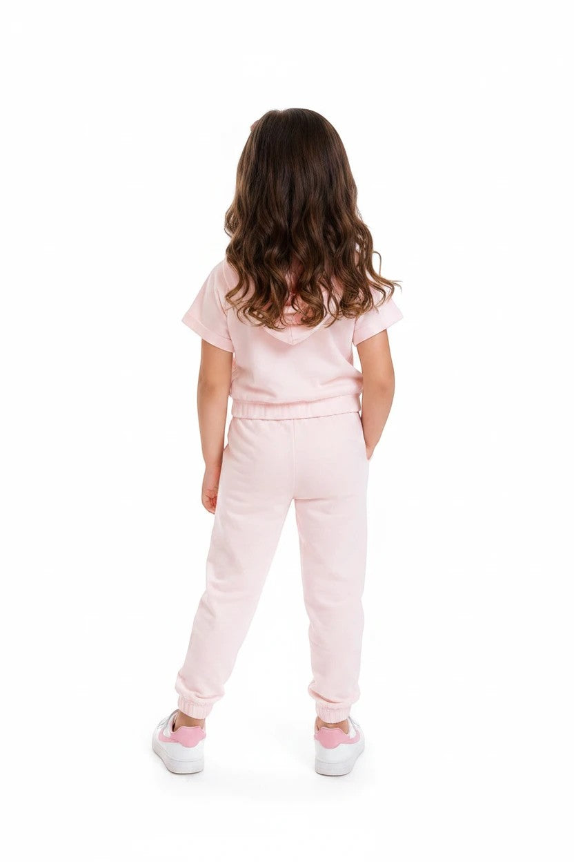 The Nile Luxuries girls light pink short sleeve hoodie and jogger lounge set, back view on a young girl.