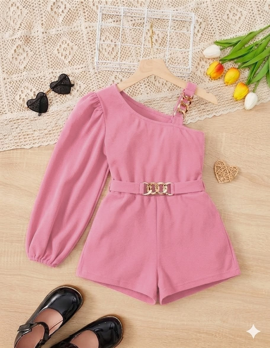 The Nile Luxuries pink one-shoulder romper with puff sleeve and gold chain belt. Girls' fashion.