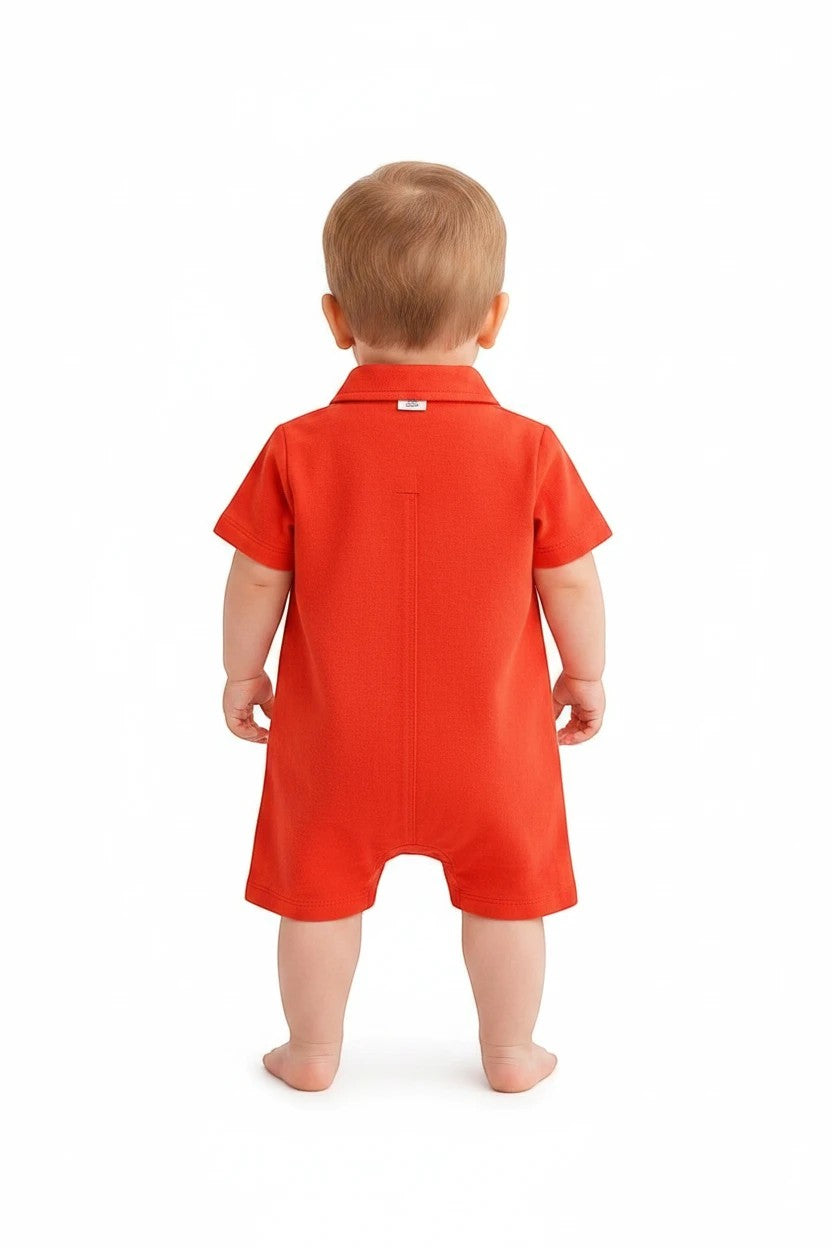 Toddler wearing a red short sleeve collared romper from The Nile Luxuries, viewed from the back.