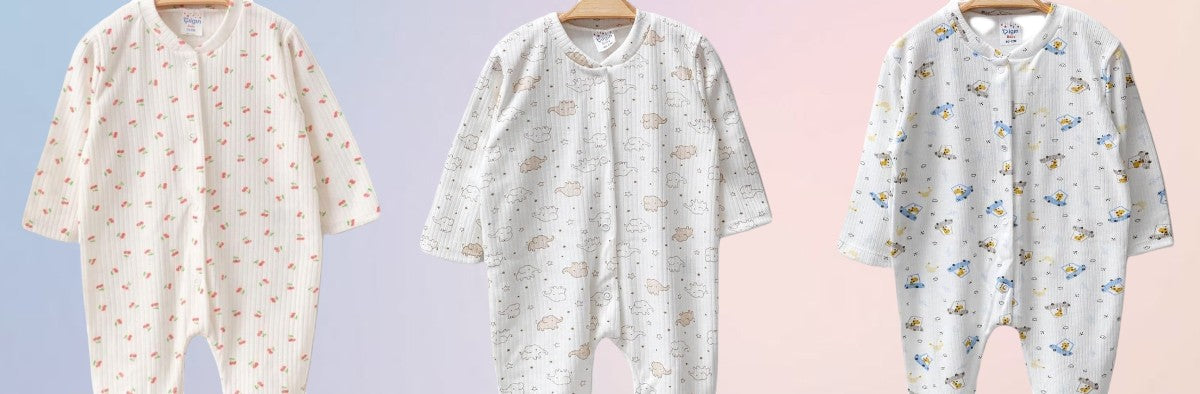 The Nile Luxuries ribbed knit baby sleepsuit with footies, available in cherry, elephant, and bear prints.