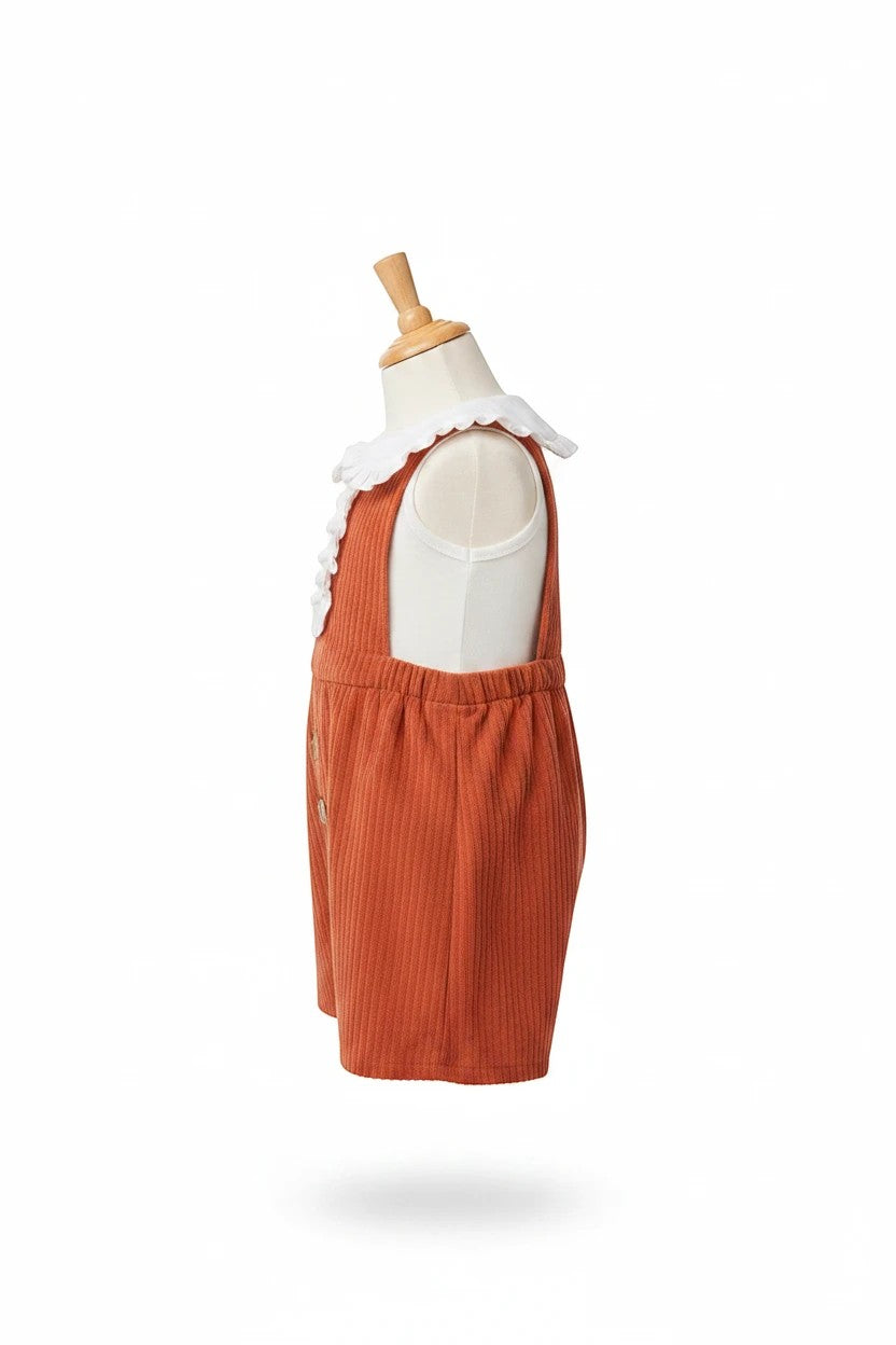 The Nile Luxuries rust-colored ribbed infant bubble romper with a white ruffled Peter Pan collar on a mannequin.