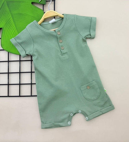 The Nile Luxuries sage green ribbed cotton baby romper with short sleeves, button placket, and front pocket.